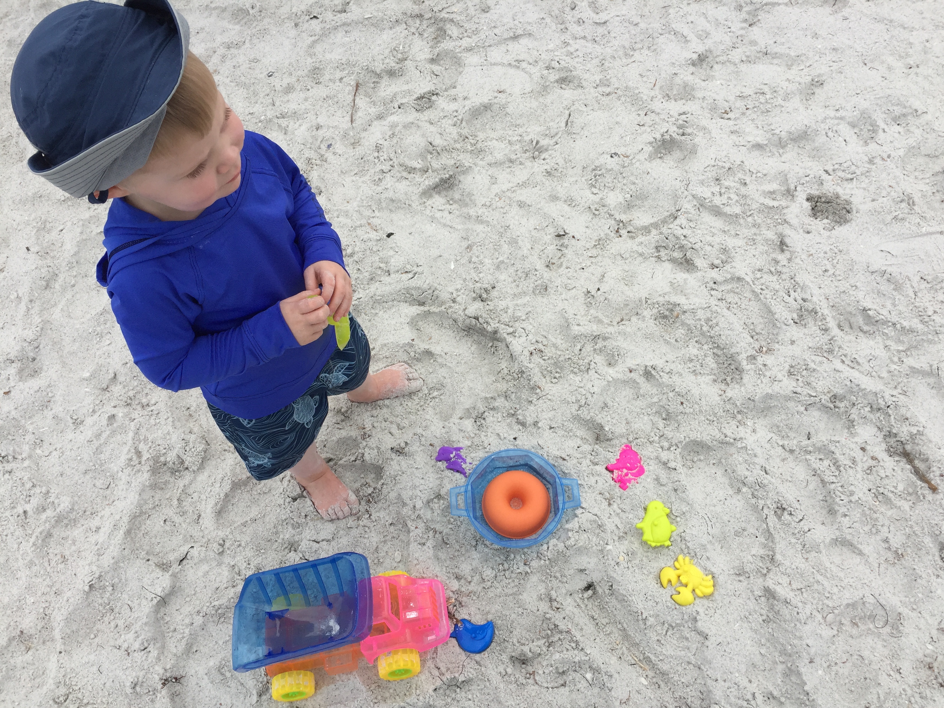 Beach time for a busy toddler on vacation but not from trucks.