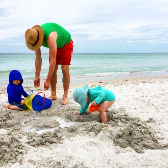 Toddler life at the beach with dad as servant.